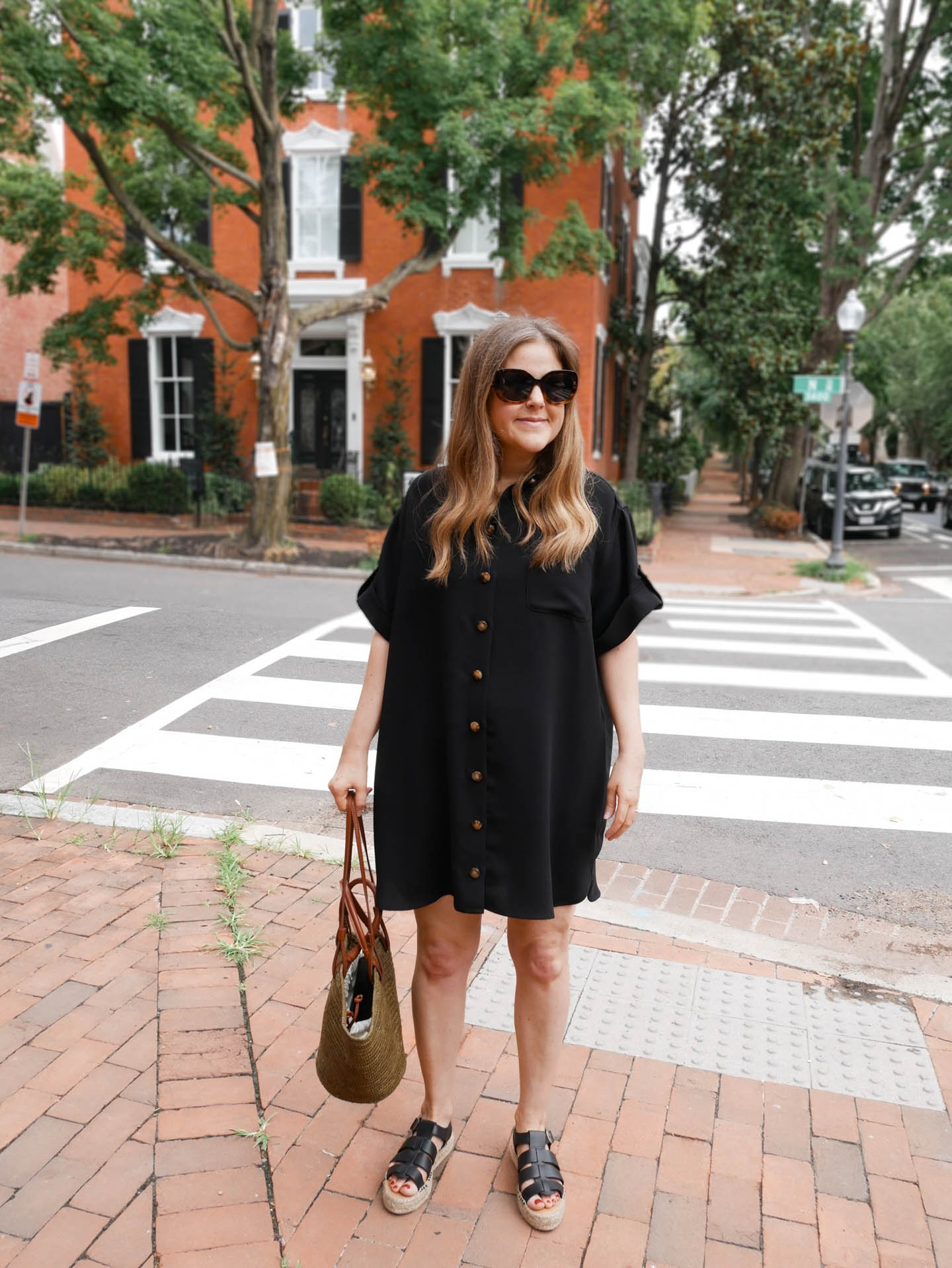 Black leather fisherman sandals styled with elegant summer dress